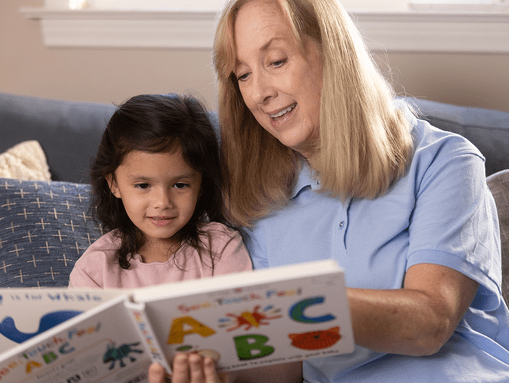 Grandmother reading to a small child
