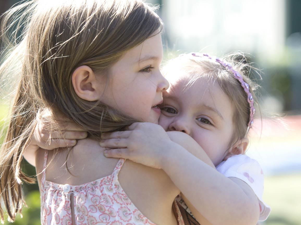 Toddler girls hugging