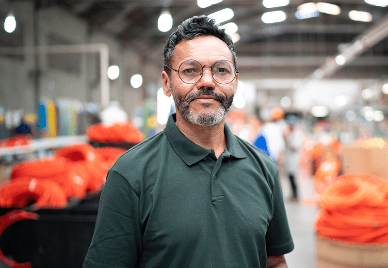 Hispanic employee happy at his job due to education benefits