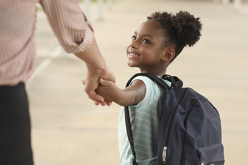 Young girl going to child care so her parents can work