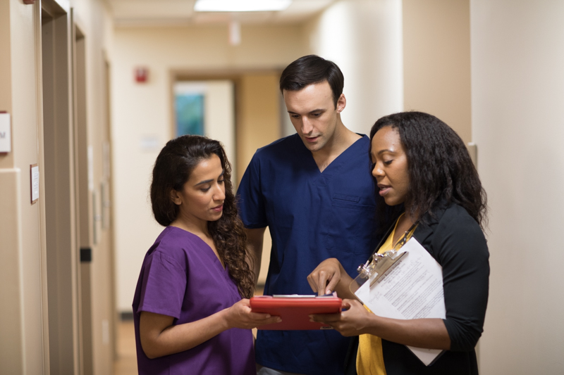 three medical frontline workers talking