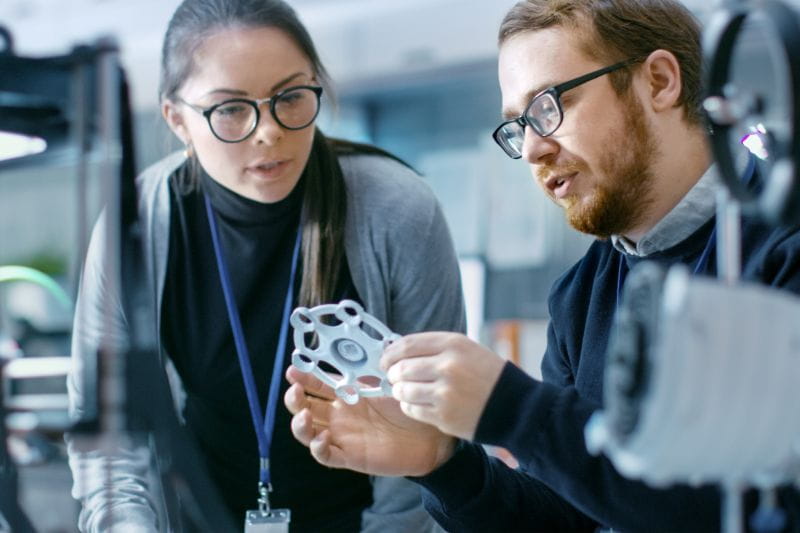 Female and male manufacturing colleagues working together