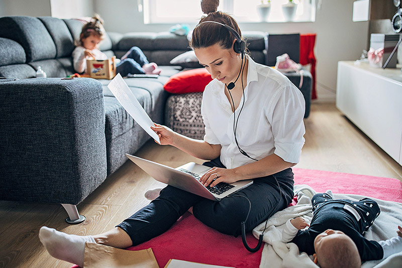 Stressed mom working from home while caring for her kids