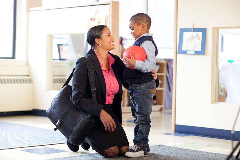 Working mom dropping her son off at child care