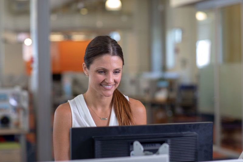 Young female professional working in the office during summer