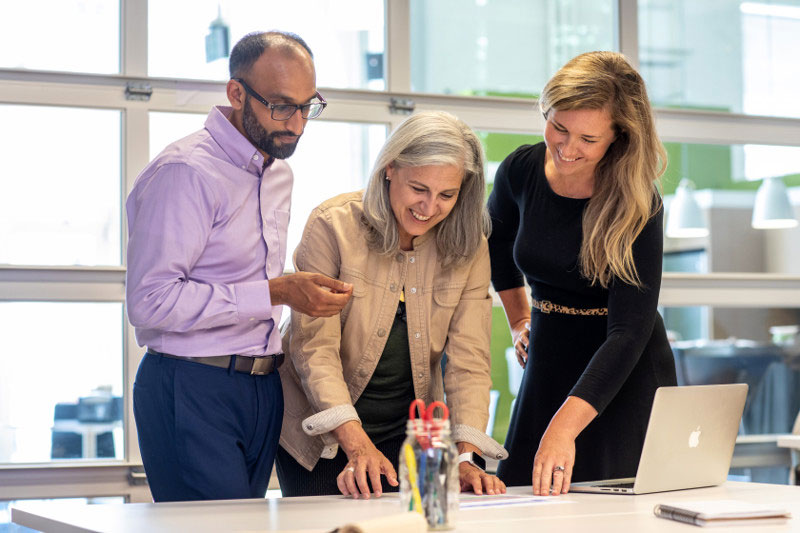 Three co-workers meeting about a project