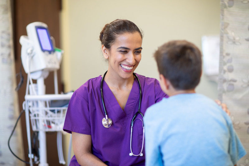 Nurse engaged in caring for her young patient