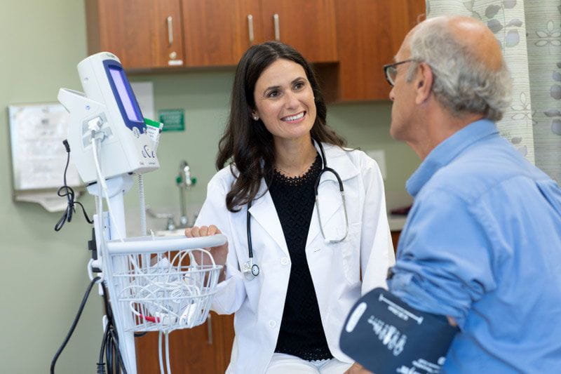 Healthcare professional taking patient's blood pressure