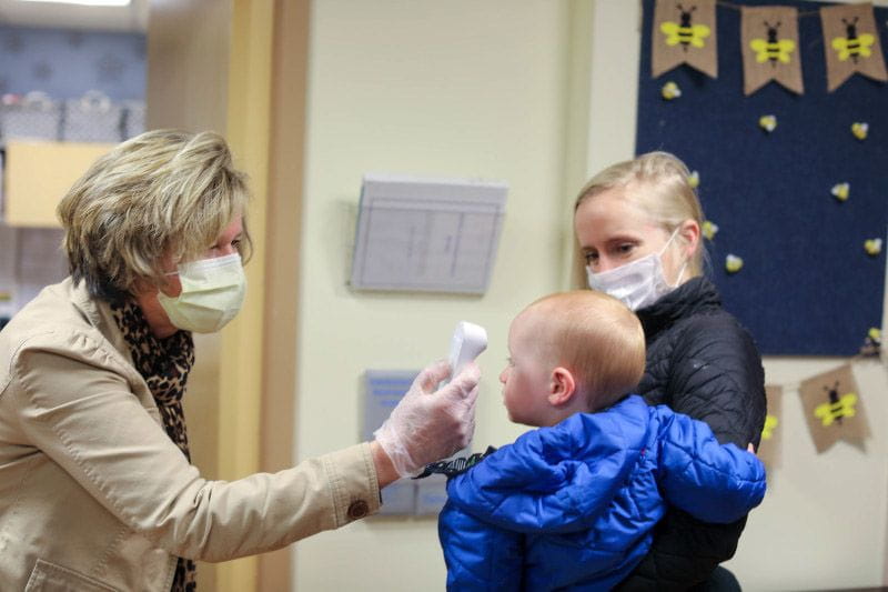 Child care center staff using enhanced safety protocols