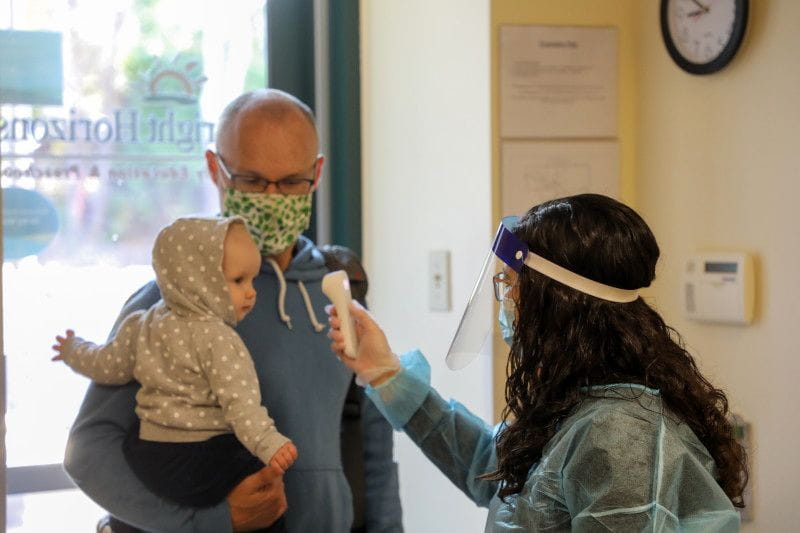 Working dad dropping baby off at daycare