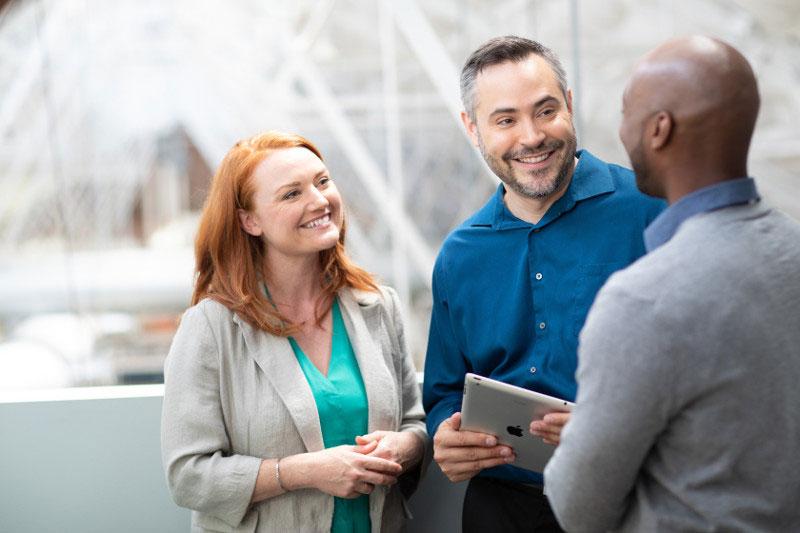 Three colleagues having a conversation in the office