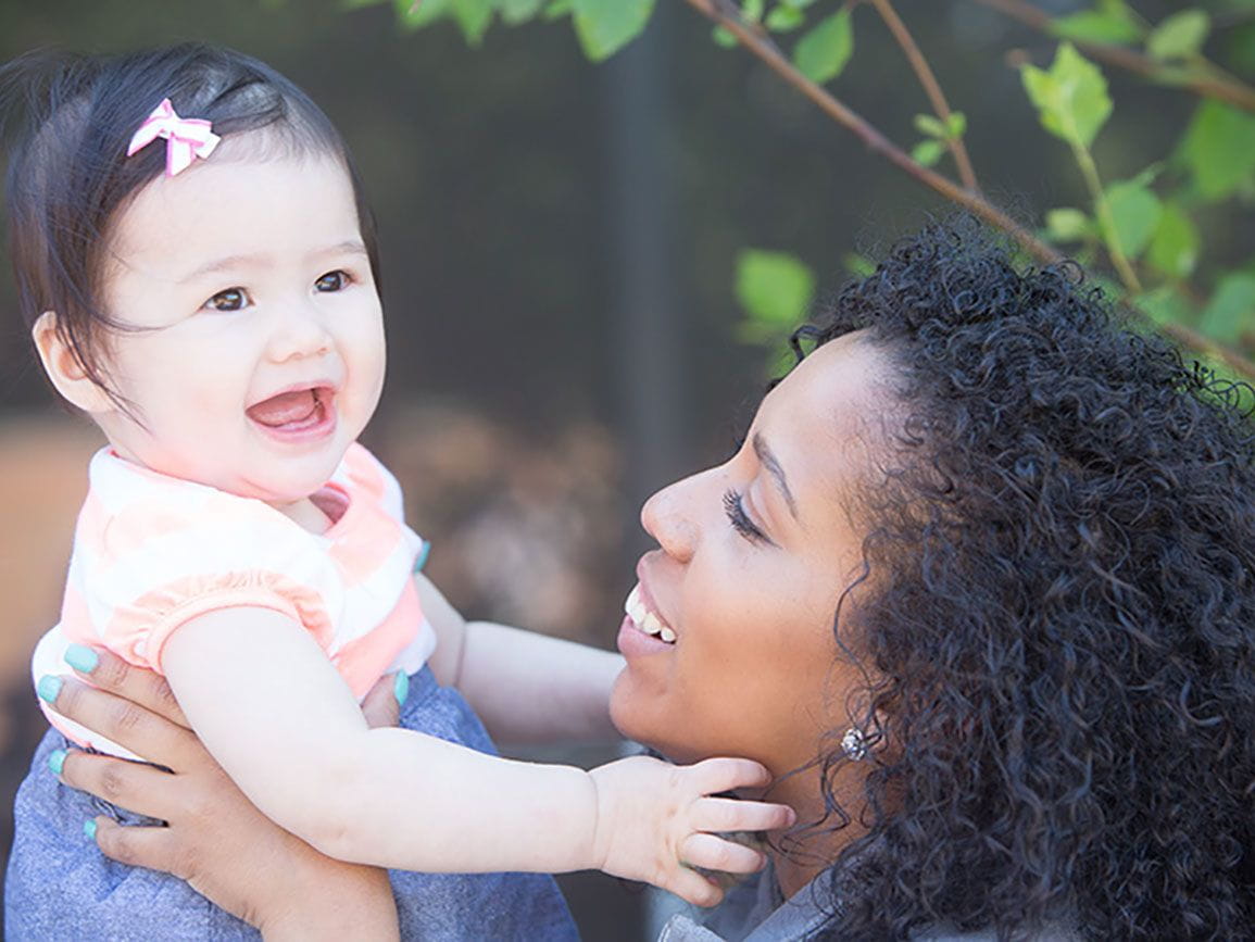 A developing toddler being held