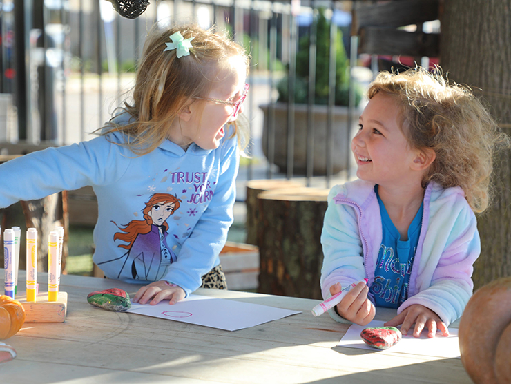 Two young girls play together and learn social skills at daycare | Bright Horizons