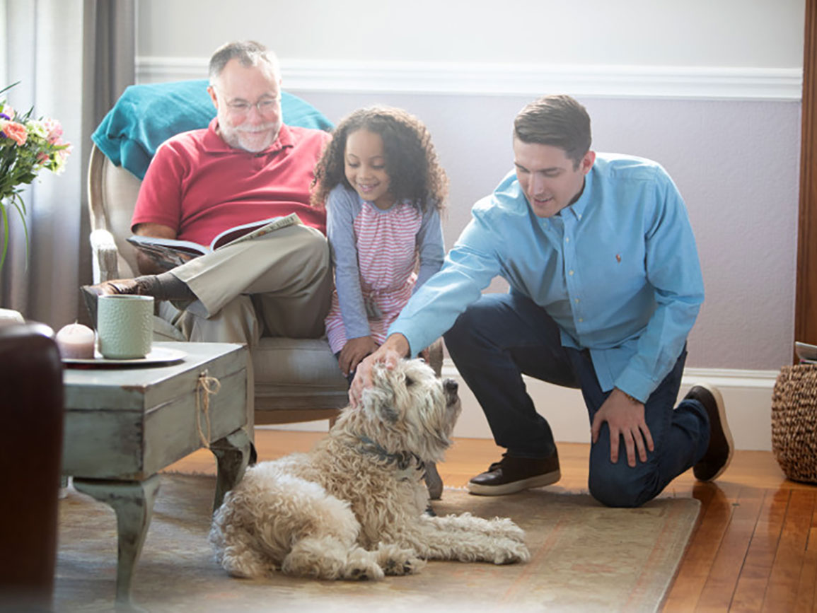 Family petting and showing kindness towards their dog