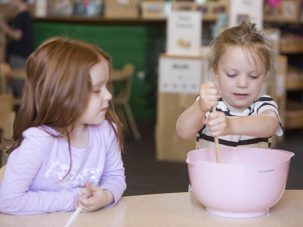 two children making food together