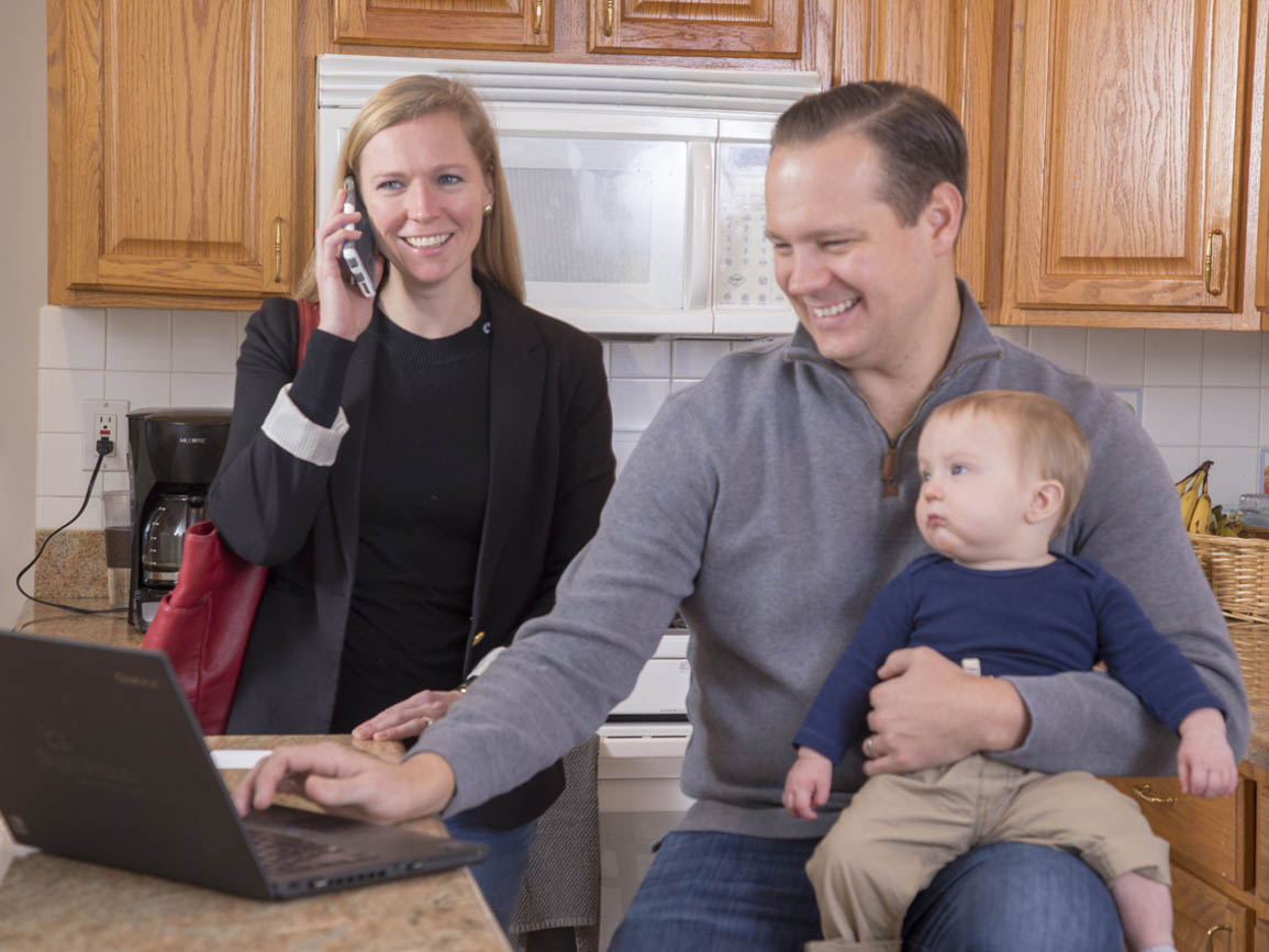 Mom and Dad working together while taking care of their infant