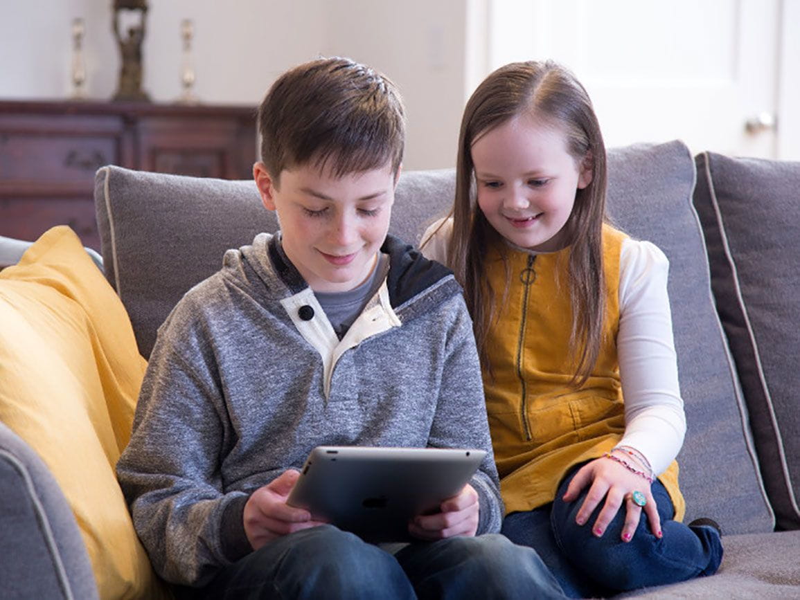 School-age boy and girl looking at an iPad together