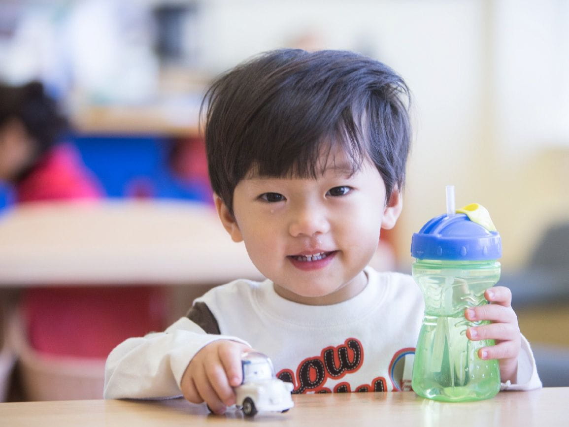 Child drinking water at center