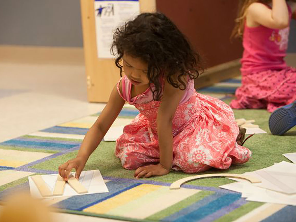 Preschool girl learning letters