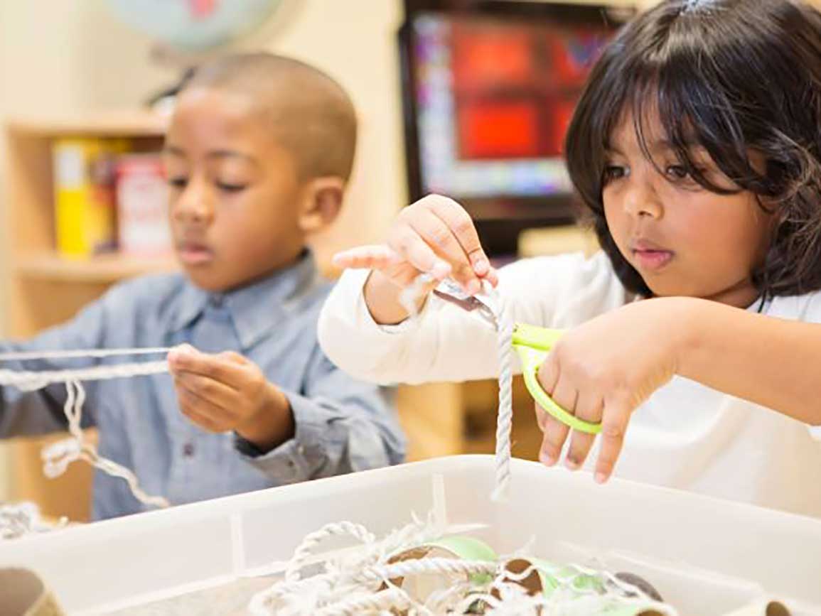 Kindergarten-aged kids making art