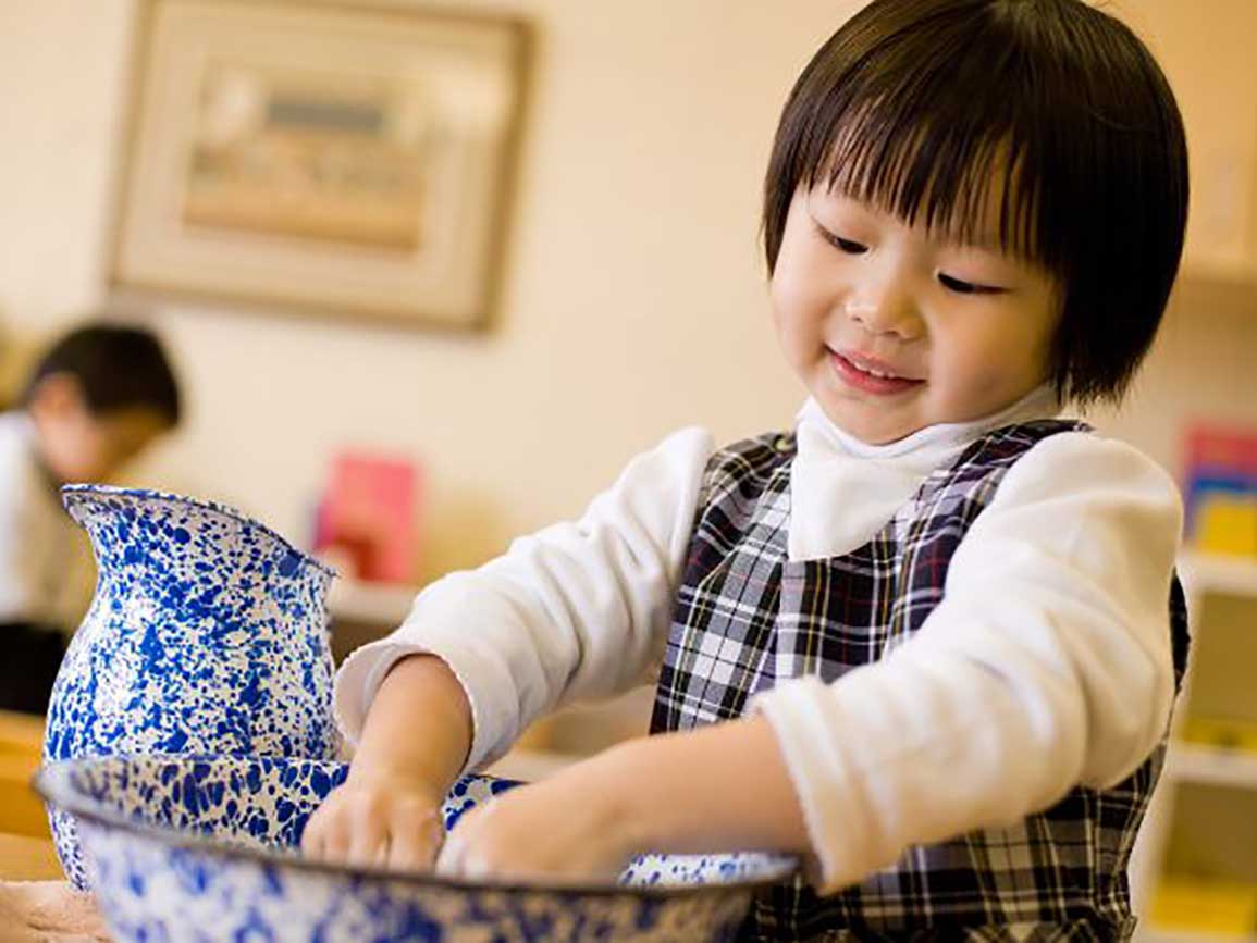 Preschool girl mixing in a bowl