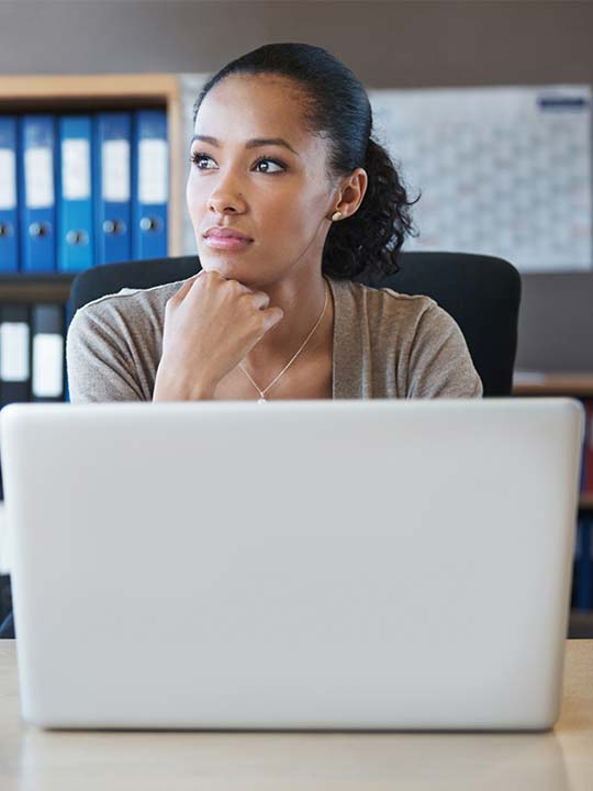 Bright Horizons Modern Family Index Women Sitting at Desk with Binders Behind Her