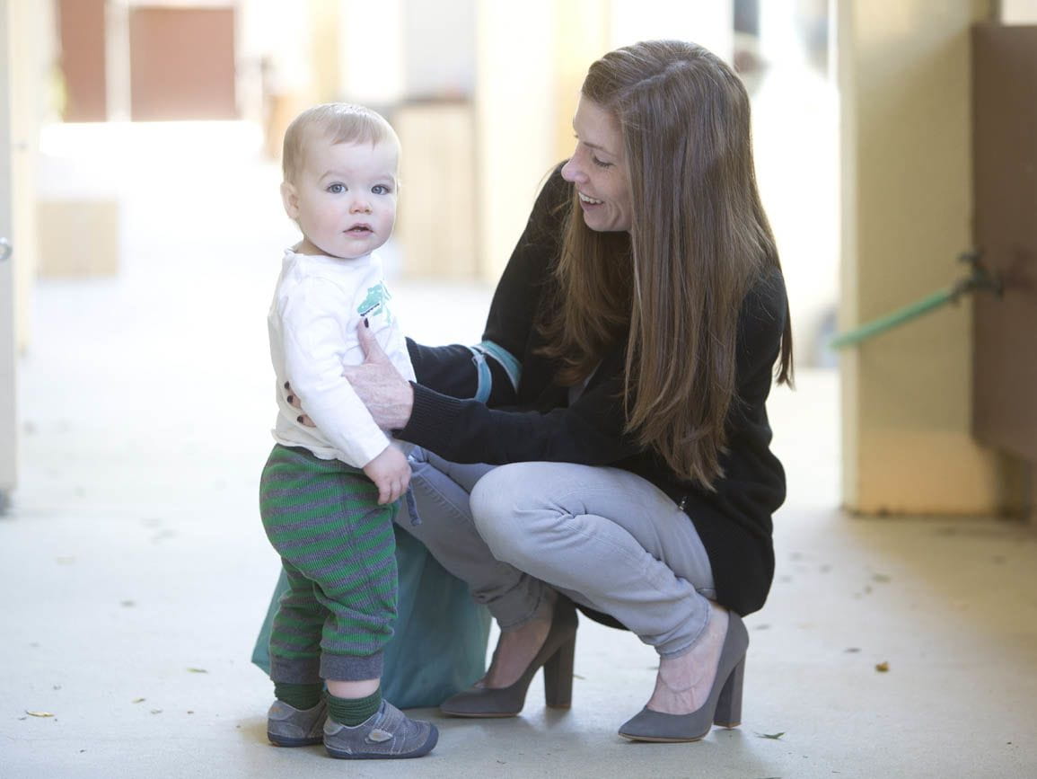 A mother and young toddler child drop off at child care