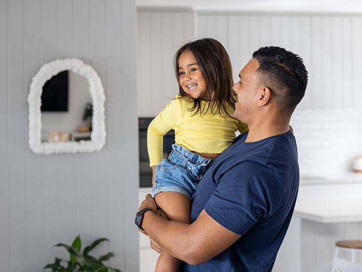 dad giving daughter a gender-neutral compliment and a hug