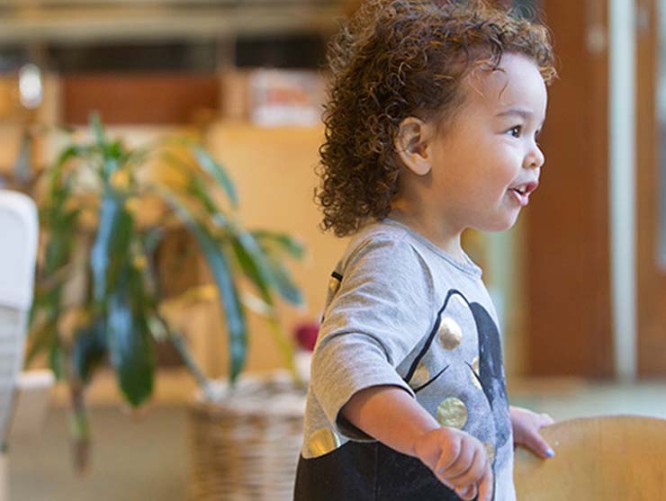 toddler boy running in an office