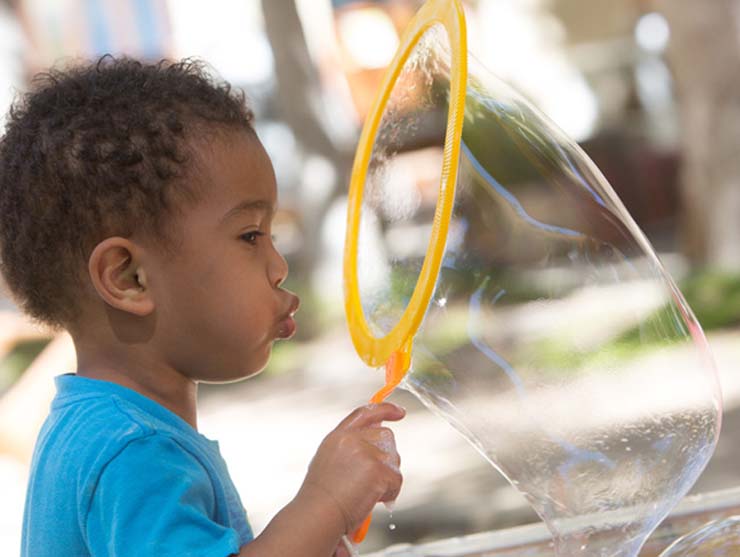 learning over the summer|Ways to Keep Kids Learning Over Summer - Little girl blowing bubbbles|Boy swimming in a pool