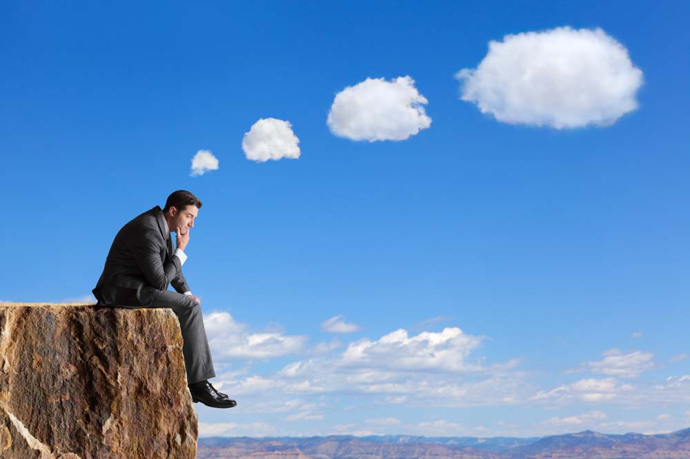Person looking out at a scenic cliffside reflecting on life decisions